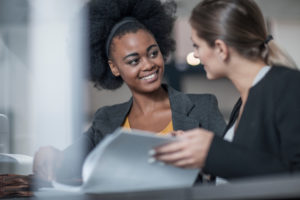 two young businesswomen meeting at office reception