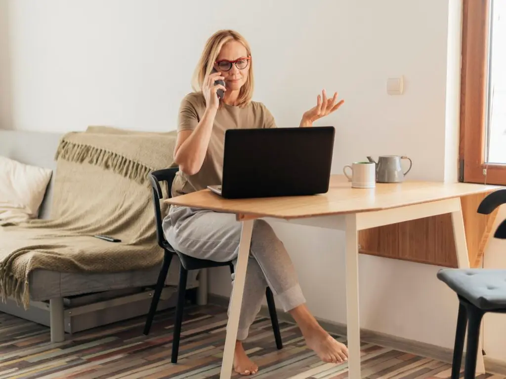 woman working home quarantine with laptop smartphone 1024x768